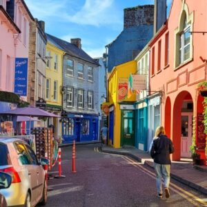 Solo traveller exploring colorful streets of Kinsale, Ireland
