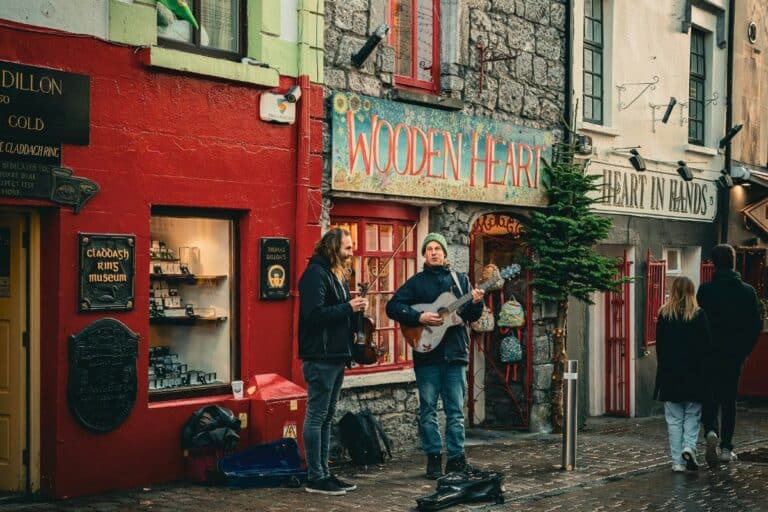 Solo traveler enjoying lively street buskers in Galway, Ireland