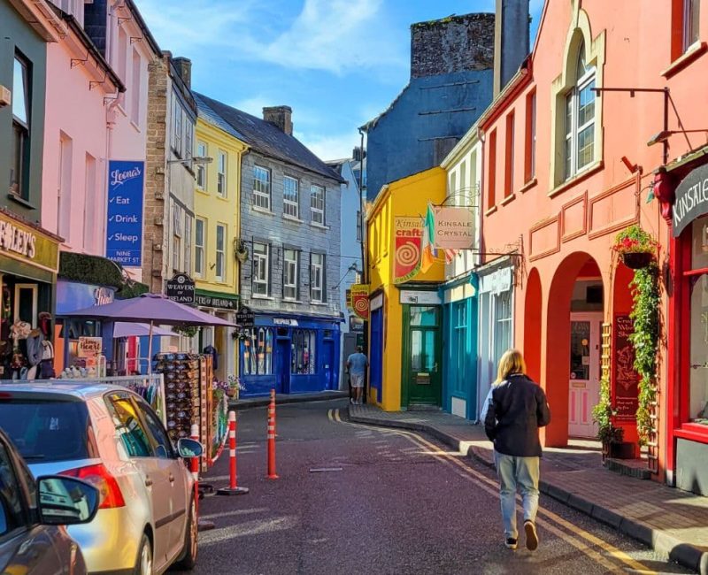 Solo traveller exploring colorful streets of Kinsale, Ireland